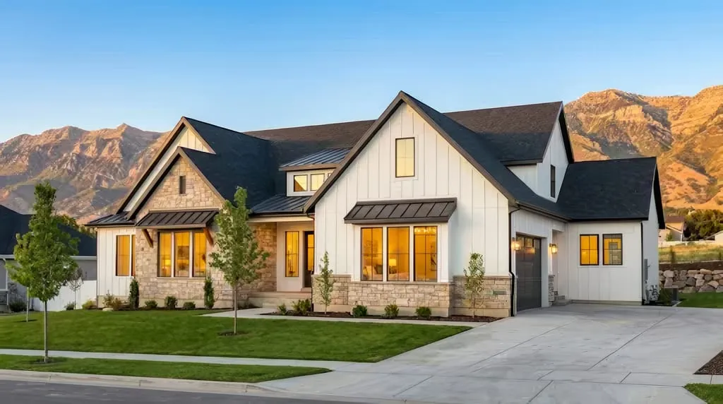 Modern Utah home with energy-efficient windows reflecting mountain views at golden hour